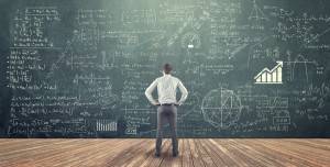 A man looking at a complex diagram on a chalkboard