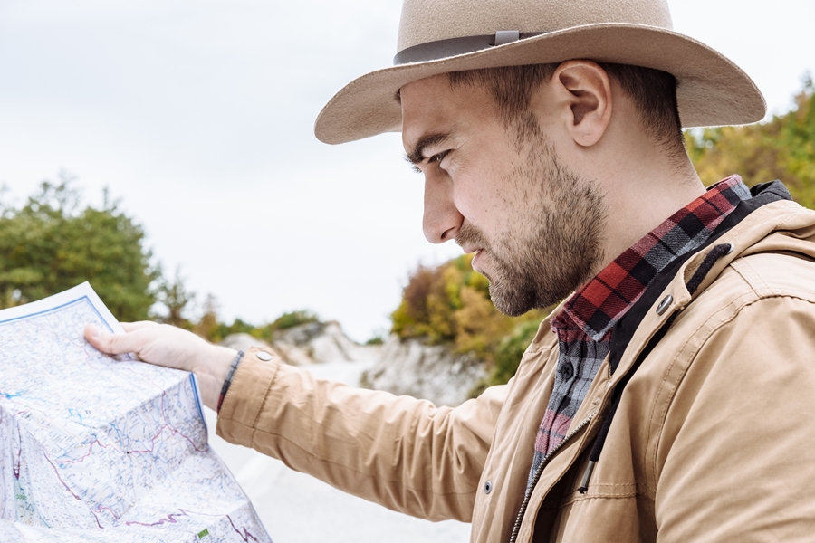 A man holding a map - The Adventures of Faith and Work