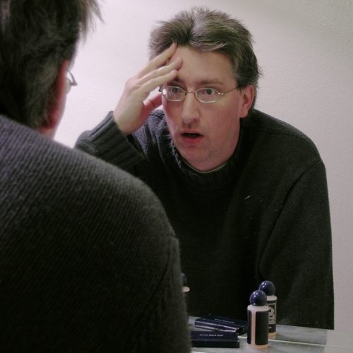 Man looking into the mirror at himself